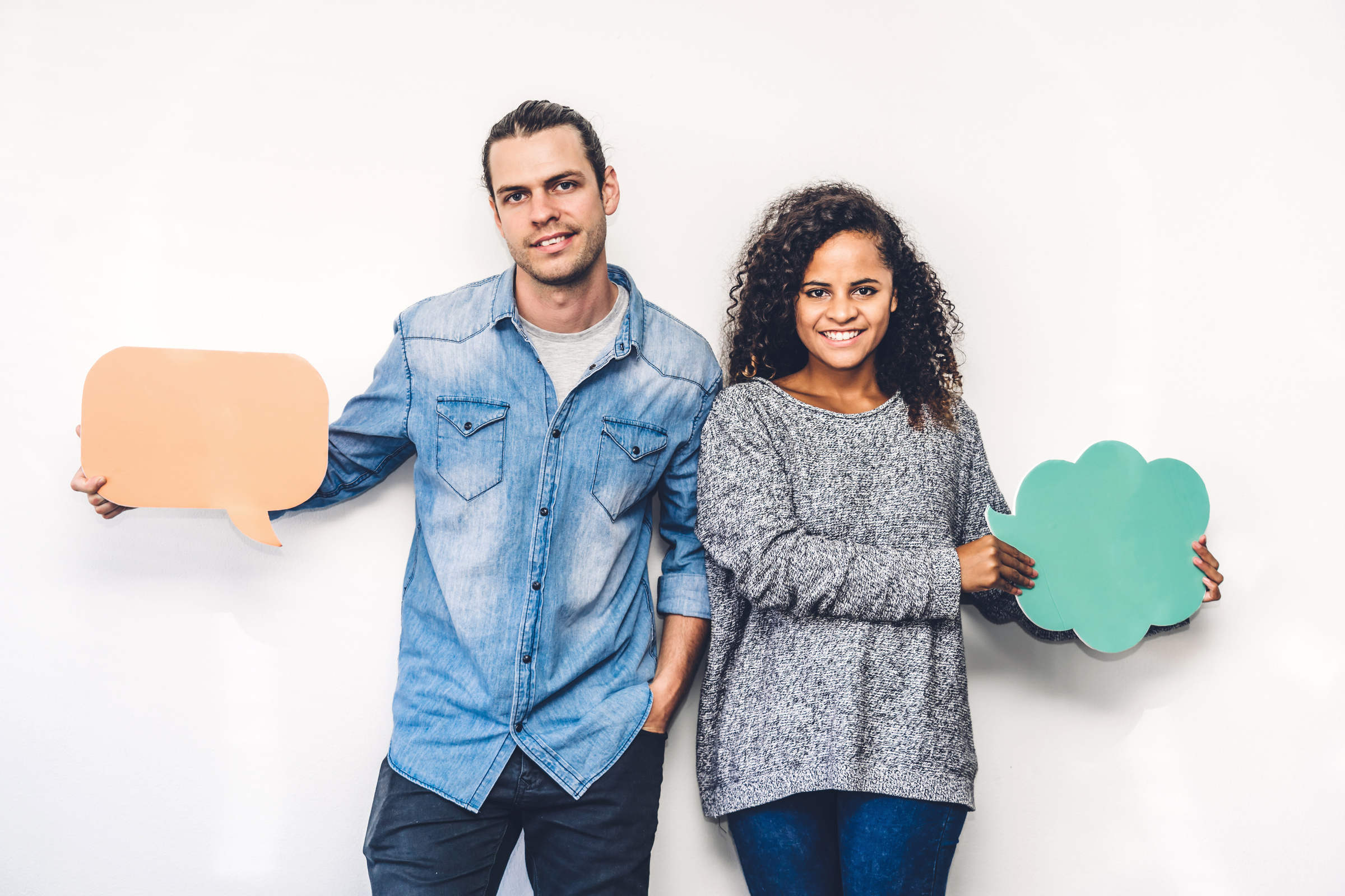 Two Friends Holding a Speech Bubble Icon Together